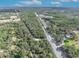 Aerial view of the property surrounded by lush greenery and adjacent to commercial development at 425 Old Chuluota Rd, Chuluota, FL 32766