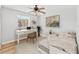 Bedroom featuring a ceiling fan, desk area by the window, and hardwood floors at 4312 Lake Underhill Rd # 19, Orlando, FL 32803