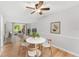 Dining area leading into living room with wood floors, ceiling fan, and sliding doors to patio at 4312 Lake Underhill Rd # 19, Orlando, FL 32803