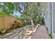 Landscaped yard with brick pavers, a table and a fence that creates a secluded outdoor space at 44 Capistrano Dr, Ormond Beach, FL 32176