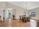 Open dining area with a dark wood table set for four under a modern chandelier at 44 Capistrano Dr, Ormond Beach, FL 32176