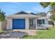 Charming home with a vibrant blue garage door and stylish brick accents at 44 Capistrano Dr, Ormond Beach, FL 32176