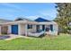 Charming home with a vibrant blue garage door and stylish brick accents at 44 Capistrano Dr, Ormond Beach, FL 32176