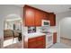 A well-lit kitchen shows white appliances, wooden cabinets, and tile countertops at 44 Capistrano Dr, Ormond Beach, FL 32176