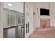 Living room with a fireplace, tile floor, and an adjacent sunroom at 44 Capistrano Dr, Ormond Beach, FL 32176