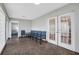 An entry area featuring tile floors, multiple seating options, and paneled doors to another room at 44 Capistrano Dr, Ormond Beach, FL 32176