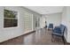 Sun room with tile floors, windows, and blue accent chairs at 44 Capistrano Dr, Ormond Beach, FL 32176