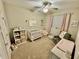 Bright, neutral Bedroom with carpet, curtains, fan, decor, and a crib at 453 Oviedo Blvd, Oviedo, FL 32765