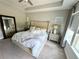 Bright bedroom with tufted headboard, neutral walls, carpet and ample natural light at 453 Oviedo Blvd, Oviedo, FL 32765