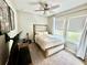 Comfortable bedroom with neutral tones, a ceiling fan, and two windows at 453 Oviedo Blvd, Oviedo, FL 32765