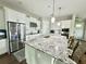 Modern kitchen with granite countertops, stainless steel appliances, and open layout to the living area at 453 Oviedo Blvd, Oviedo, FL 32765