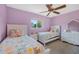 Inviting bedroom with two twin beds, ceiling fan and large window at 460 Forestwood Ln, Maitland, FL 32751