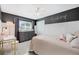 Cozy bedroom featuring a gray accent wall with white wainscotting and a ceiling fan at 460 Forestwood Ln, Maitland, FL 32751