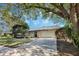 Inviting home showcasing a lush front lawn, two-car garage, and stone details at 460 Forestwood Ln, Maitland, FL 32751