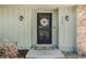 Close-up of the front door with a floral wreath and decorative welcome mat at 460 Forestwood Ln, Maitland, FL 32751