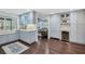 Bright kitchen featuring gray cabinets, subway tile backsplash, wine storage, and hardwood floors at 460 Forestwood Ln, Maitland, FL 32751