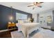 Serene main bedroom featuring a king-size bed, stylish decor, and french doors providing ample light at 460 Forestwood Ln, Maitland, FL 32751