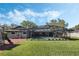 Backyard pool with a screened enclosure and manicured green lawn, creating an outdoor oasis for relaxation and recreation at 460 Forestwood Ln, Maitland, FL 32751