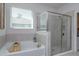 Bathroom featuring a soaking tub with wood tray and a separate glass-enclosed shower at 5142 Sage Cedar Pl, Sanford, FL 32771