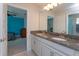 Stylish bathroom with double sinks and granite countertops, plus bedroom view at 5142 Sage Cedar Pl, Sanford, FL 32771