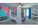 Stylish bedroom with a canopy bed, colorful geometric accent wall, and natural light at 5142 Sage Cedar Pl, Sanford, FL 32771