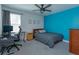 Cozy bedroom features an accent wall, ceiling fan, and functional desk space at 5142 Sage Cedar Pl, Sanford, FL 32771