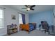 Bedroom featuring stylish blue accent wall, fan, and natural light window at 5142 Sage Cedar Pl, Sanford, FL 32771