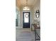 Well-lit foyer with tile flooring, console table, mirror, and decorative wreath on the front door at 5142 Sage Cedar Pl, Sanford, FL 32771