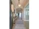 Inviting foyer with tile floors, light fixture, console table, mirror, and view into the home at 5142 Sage Cedar Pl, Sanford, FL 32771