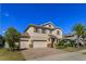 Two-story home with a three-car garage, brick driveway, and well-maintained lawn and landscaping at 5142 Sage Cedar Pl, Sanford, FL 32771