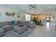 Open-concept living room with a large sectional sofa, open to the kitchen and dining area at 5142 Sage Cedar Pl, Sanford, FL 32771