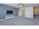 Upstairs loft area with a television, white walls and neutral carpet at 5142 Sage Cedar Pl, Sanford, FL 32771