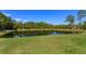 Beautiful backyard pond view for community residents with mature trees and green surroundings at 5142 Sage Cedar Pl, Sanford, FL 32771