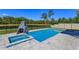 Sparkling pool with attached spa and rock climbing feature and water view at 5142 Sage Cedar Pl, Sanford, FL 32771