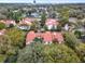 Community aerial view showcasing red tile roofs surrounded by lush green trees with city views at 520 Via Verona Lane # 103, Altamonte Springs, FL 32714