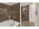 Beautiful bathroom showcasing a soaking tub, glass shower, and stylish tile work at 520 Via Verona Lane # 103, Altamonte Springs, FL 32714