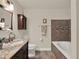 Inviting bathroom features a soaking tub, granite countertops, dark wood cabinetry, and decorative tile accents at 520 Via Verona Lane # 103, Altamonte Springs, FL 32714