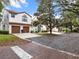 Well-maintained townhomes with garages, set against a landscaped background and community at 520 Via Verona Lane # 103, Altamonte Springs, FL 32714