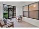 Relaxing screened porch with comfortable seating and a view of the lush landscaping outside at 520 Via Verona Lane # 103, Altamonte Springs, FL 32714