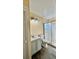 Bright bathroom with a white vanity, modern lighting, and glass enclosed shower at 5317 Hyde Park Ave, Orlando, FL 32808