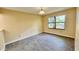 Neutral bedroom with a large window and wood-look tile flooring throughout at 5317 Hyde Park Ave, Orlando, FL 32808