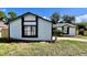 Charming single-story home featuring white siding and bold black trim around the windows at 5317 Hyde Park Ave, Orlando, FL 32808