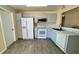 Well-lit kitchen with grey cabinets, stainless steel appliances, and tile flooring at 5317 Hyde Park Ave, Orlando, FL 32808