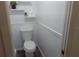 Neat bathroom with classic white toilet, decorative shelves, and fresh paint at 554 Lancer Oak Dr, Apopka, FL 32712