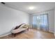 Empty bedroom featuring wood floors, a large window, and a lounge chair at 611 Aldama Ct, Ocoee, FL 34761