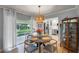 Cozy dining area with pendant lighting and sliding glass doors to the outdoor living space and modern kitchen at 611 Aldama Ct, Ocoee, FL 34761