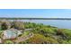 Aerial view of a lakefront community featuring a pool, wooden bridge, and lush landscaping at 6336 Buford St # 706, Orlando, FL 32835