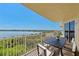 Balcony with dining furniture and picturesque lake views at 6336 Buford St # 706, Orlando, FL 32835