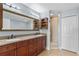 Bathroom featuring double vanity, large mirror, and walk-in shower at 6336 Buford St # 706, Orlando, FL 32835