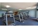 Fully equipped gym featuring treadmills and weight machines with blue carpet, perfect for residents' fitness needs at 6336 Buford St # 706, Orlando, FL 32835